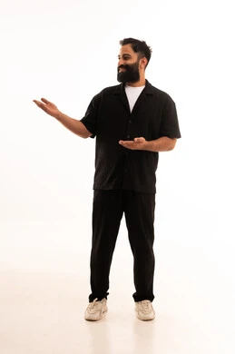 حمل ورفع شيء ما، الدلالة على مكان عنصر، بورتريه لرجل عربي خليجي عماني مبتسم يرتدي الزي الكاجوال يشير بيده الى شئ ما ، تحديد موقع أو هدف معين، مفهوم الإشارة والتوجيه، الجسم بالطول الكامل، خلفية بيضاء