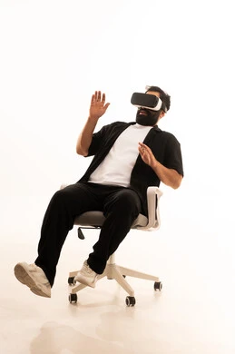 Simulation of the imaginary world, expressions of immersion and interaction, wearing virtual reality glasses, using modern technological devices, a portrait of an Arab Gulf Omani man wearing casual attire and 3D VR glasses, having a good time playing video games, white background.