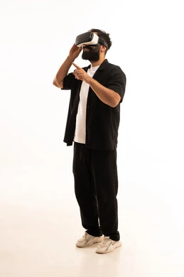 Expressions of immersion and interaction, simulating the imaginary world, wearing virtual reality glasses, using modern technological devices, a portrait of an Arab Gulf Omani man wearing casual attire and putting on 3D VR glasses, having a good time playing video games, white background.