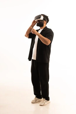 Expressions of immersion and interaction, simulating the imaginary world, wearing virtual reality glasses, using modern technological devices, a portrait of an Arab Gulf Omani man wearing casual attire and putting on 3D VR glasses, having a good time playing video games, white background.