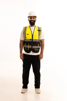 Working in the engineering sector, the concept of engineering and architectural constructions, a portrait of an Arab Gulf Omani engineer wearing casual attire, a helmet, and a safety vest, looking with expressions of joy, a profession and job for youth in the Sultanate of Oman, full-body, white background.