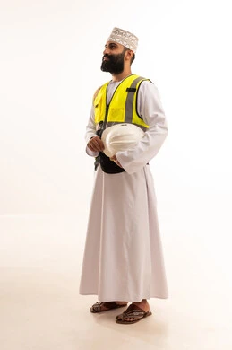 The concept of engineering and architectural construction, working in the engineering sector, a portrait of an Arab Gulf Omani engineer wearing a dishdasha and kumma and a safety vest holding a white helmet with expressions of joy, a profession and job for youth in the Sultanate of Oman, full-body, white background.