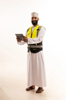 Project management with professionalism using a tablet, integrating modern technologies, working in the engineering sector, the concept of engineering and architectural constructions, a portrait of an Arab Gulf Omani engineer wearing a dishdasha and kumma and a safety vest holding a tablet in his hand, white background.