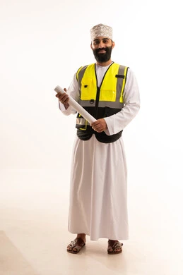 A portrait of an Arab Gulf Omani engineer wearing a dishdasha, kumma, and safety vest, holding a blueprint in his hands, working in the field of engineering, a profession and job for youth in the Sultanate of Oman, supervising engineering project plans, the concept of architectural constructions, full-body shot, white background.