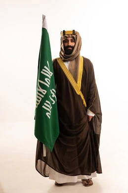 The anniversary of the establishment of the first Saudi state is on February 22, the day we began in 1727 AD. The commemoration of the Saudi National Day is on September 23. A portrait of an Arab Saudi Gulf man wearing a bisht, ghutrah, and agal on the day of establishment, raising the Saudi flag. Flag Day is on March 11, with a white background. The anniversary of the establishment of the first Saudi state is on February 22, the day we began in 1727 AD. The commemoration of the Saudi National Day is on September 23. A portrait of an Arab Saudi Gulf man wearing a bisht, ghutrah, and agal on the day of establishment, raising the Saudi flag. Flag Day is on March 11, with a white background.