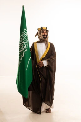 The day we started was 1727 AD, the anniversary of the establishment of the first Saudi state on February 22, the commemoration of Saudi National Day on September 23, a portrait of an Arab Saudi Gulf man wearing a bisht, ghutrah, and agal on the day of establishment raising the Saudi flag, Flag Day on March 11, white background. The day we started was 1727 AD, the anniversary of the establishment of the first Saudi state on February 22, the commemoration of Saudi National Day on September 23, a portrait of an Arab Saudi Gulf man wearing a bisht, ghutrah, and agal on the day of establishment raising the Saudi flag, Flag Day on March 11, white background.