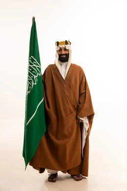 On the day we began in 1727, the anniversary of the establishment of the first Saudi state on February 22, the commemoration of Saudi National Day on September 23, a portrait of an Arab Saudi Gulf man wearing a bisht, ghutrah, and agal on the day of establishment raising the Saudi flag, Flag Day on March 11, white background. On the day we began in 1727, the anniversary of the establishment of the first Saudi state on February 22, the commemoration of Saudi National Day on September 23, a portrait of an Arab Saudi Gulf man wearing a bisht, ghutrah, and agal on the day of establishment raising the Saudi flag, Flag Day on March 11, white background.