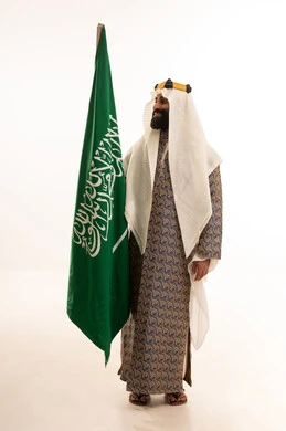 Commemoration of the Saudi National Day, September 23, a portrait of an Arab Saudi Gulf man wearing a bisht, ghutrah, and igal on Foundation Day raising the Saudi flag, Flag Day March 11, the anniversary of the establishment of the first Saudi state on February 22, the day we started in 1727, white background.