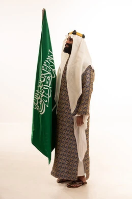 The anniversary of the establishment of the first Saudi state is on February 22, the day we began in 1727 AD. The commemoration of the Saudi National Day is on September 23. A portrait of an Arab Saudi Gulf man wearing a bisht, ghutrah, and agal on the day of establishment, raising the Saudi flag. Flag Day is on March 11, with a white background. The anniversary of the establishment of the first Saudi state is on February 22, the day we began in 1727 AD. The commemoration of the Saudi National Day is on September 23. A portrait of an Arab Saudi Gulf man wearing a bisht, ghutrah, and agal on the day of establishment, raising the Saudi flag. Flag Day is on March 11, with a white background.