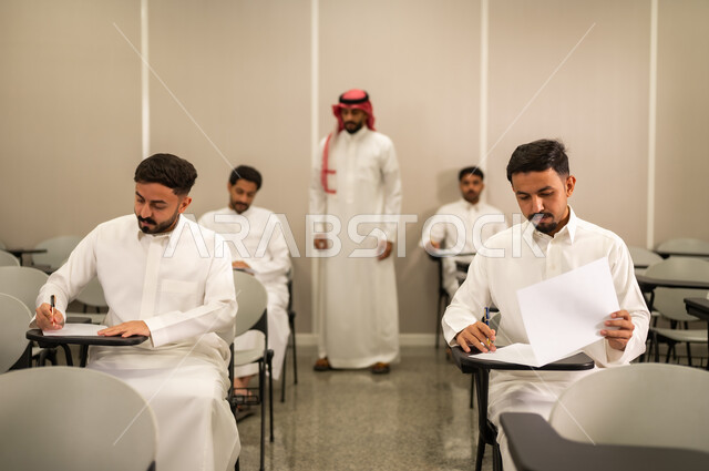 Monitoring students during exams; Arab Gulf and Saudi students answer exam questions; educational objectives; final exams; end of semester; education in Saudi Arabia