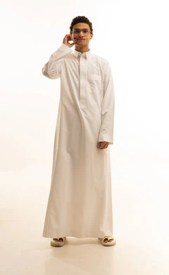 Authentic Arab masculinity, attention to appearance, looking at the camera with gestures of seriousness, the concept of handsome and self-confidence, a portrait of a Saudi Gulf Arab man wearing traditional attire and glasses, holding his mustache, giving sincere promises, full-body, white background.