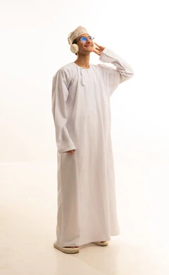 Gestures of immersion with the song, interaction with musical melodies using headphones, a portrait of an Arab Gulf Omani man wearing a dishdasha and kumma and glasses, listening to music through headphones with expressions of listening and enjoyment, artistic singing talent, full-body, white background. Gestures of immersion with the song, interaction with musical melodies using headphones, a portrait of an Arab Gulf Omani man wearing a dishdasha and kumma and glasses, listening to music through headphones with expressions of listening and enjoyment, artistic singing talent, full-body, white background.