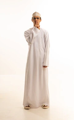 Prohibition of doing something, silence and stopping talking, a portrait of an Arab Gulf Omani man wearing a dishdasha and kumma and medical glasses raising his finger upwards, a request to lower the volume and a threat, a full-body image, white background.