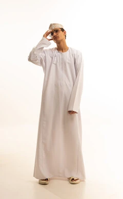 Feeling exhausted and losing focus, forgetfulness and trying to remember something, feeling of tightness and migraine, a portrait of an Arab Gulf Omani man wearing a dishdasha and kumma and medical glasses, placing his hands on his head with gestures of severe pain in the brain and head, full body, white background.