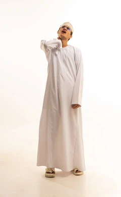 Feeling tired and exhausted, severe pain in the neck and cervical area, joint pain, a portrait of an Arab Gulf Omani man wearing a dishdasha and kumma and medical glasses, placing his hand on his neck with gestures of extreme weakness, white background.