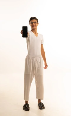 A display of a blank black screen on a mobile phone, gestures of joy and happiness, a portrait of an Arab Gulf Saudi man wearing white pants and a t-shirt holding a mobile phone in his hand, integrating advanced technology into daily life, using a modern and advanced technical device, white background.