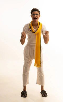 A portrait of a Saudi Arabian Gulf man wearing white pants and a white t-shirt with a scarf, raising his hand with expressions of excitement and interaction with the national team, different sports clubs, gestures of passion and encouragement for the team, watching and following a football match, with a white background.