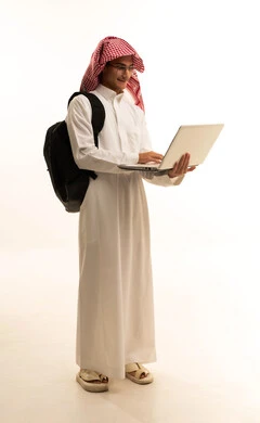 The concept of distance education, educational materials and curricula in the Kingdom, following lectures through advanced educational platforms, a portrait of a Saudi Arabian Gulf man wearing traditional attire and a shemagh, with a backpack and a laptop, full-body image, white background.