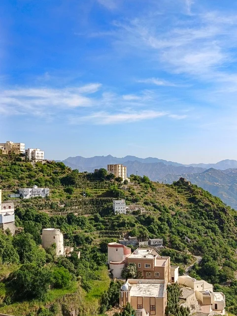 Old houses and homes, the landscapes of nature in the province of Faifa in the Jazan region in the south of the Kingdom of Saudi Arabia, natural landmarks and tourist attractions, green agricultural terraces and trees on the peaks and mountain heights, nature background.