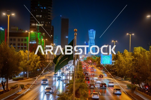 لوحات طرقية زرقاء، علم المملكة راية التوحيد الخضراء، الفن الهندسي المعماري لبرج مضاء في مدينة الرياض في وقت الليل، معالم تجارية واقتصادية وسياحية مشهورة في العاصمة، الفن الهندسي المعماري للمنشآت، النمو والتطور العمراني على الطراز الحديث والمتطور للأبراج