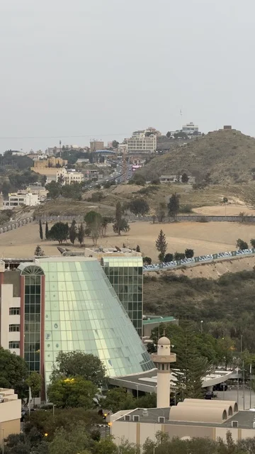 One of the hotels in Abha, spending enjoyable time on recreational tourist trips, famous tourist places and landmarks, areas of peaks and mountainous heights, the natural scenery in Abha in the Asir region of the Kingdom of Saudi Arabia, the mountains of Abha covered with clouds and mist, trees and green plants.