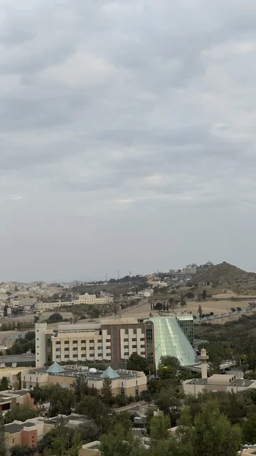 Famous tourist places and landmarks, areas of peaks and mountainous heights, spending enjoyable time on recreational tourist trips, the natural landscapes in Abha in the Asir region of the Kingdom of Saudi Arabia, the mountains of Abha covered with clouds and mist, trees and green plants.