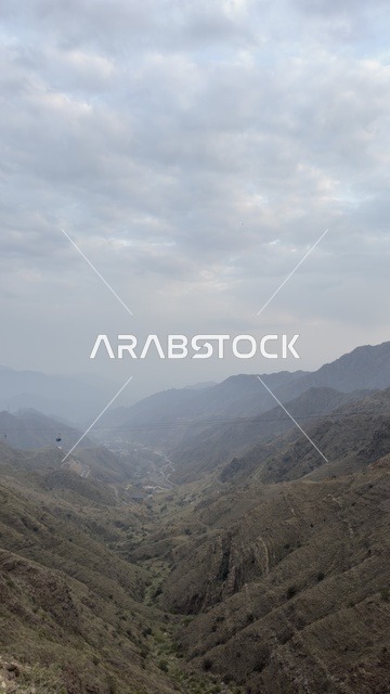 Spending enjoyable time on recreational tourist trips, famous tourist places and landmarks, areas of peaks and mountainous heights, the natural scenery in Abha in the Asir region of the Kingdom of Saudi Arabia, the mountains of Abha covered with clouds and mist, the green trees and plants.