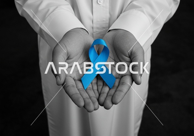 الحفاظ على الصحة الجسدية، شعار الوعي بسرطان البروستاتا ، حملات الإرشاد والتنبيه للكشف المبكر عن سرطان البروستات، بورتريه مقرب لشاب عربي خليجي سعودي يرتدي الزي التقليدي والشماغ يحمل شريط أزرق للتوعية بالأمراض، خلفية سوداء