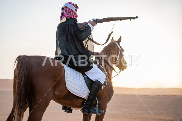A Saudi Gulf rider riding horses in the picturesque Saudi desert ...