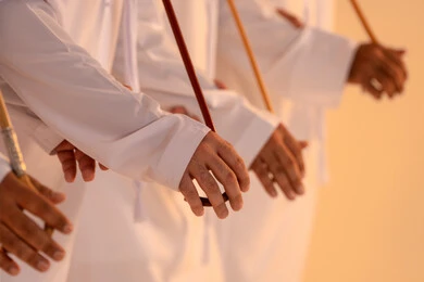 Performance of Emirati folk arts, celebrating national and heritage occasions, a portrait of a group of Emirati Gulf Arab men wearing the kandura and ghutrah performing the traditional Ayala dance, gestures of joy and pride in national identity, preserving cultural heritage and authentic customs.
