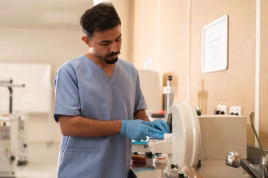 Treatment of dental caries and placement of restorative fillings, the concept of practical training, a university student in the dental college wearing gloves using medical devices.