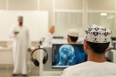 Raising hands to ask questions in the classroom, an Arab Gulf Omani university professor wearing a dishdasha and kumma is explaining to his students in the lecture, listening to the lecture, academic universities in the Sultanate of Oman, developed colleges and universities.