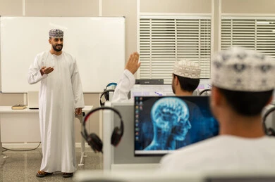 Participation by raising hands, an Arab Gulf Omani university professor wearing a dishdasha and kumma explains to his students in the lecture, listening to the lecture, academic universities in the Sultanate of Oman, developed colleges and universities. Participation by raising hands, an Arab Gulf Omani university professor wearing a dishdasha and kumma explains to his students in the lecture, listening to the lecture, academic universities in the Sultanate of Oman, developed colleges and universities.