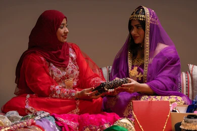 تقديم الهدايا في المناسبات، الاطلالة المتألقة ومفهوم التزين، احتفالات سعيدة ومناسبات وأفراح، الاهتمام والعناية بالأناقة والجمال، منتجات ومساحيق التجميل، سيدتان عربيتان خليجيتان اماراتيتان يرتدون الازياء التقليدية يقوموا بعرض الفساتين والمجوهرات، الاحتفال بليلة العمر