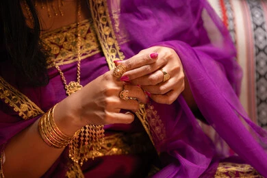 قياس خاتم ذهبي التفاخر بالحلي، منتجات ومساحيق التجميل، التقاليد في التقدم لطلب يد الفتاة، احتفالات سعيدة ومناسبات، صورة مقربة لسيدة عربية خليجية اماراتية تقوم باستعراض التحضيرات والتجهيزات للزفاف ترتدي الملابس التقليدية، إيماءات السعادة والفرح، الاحتفال بليلة العمر