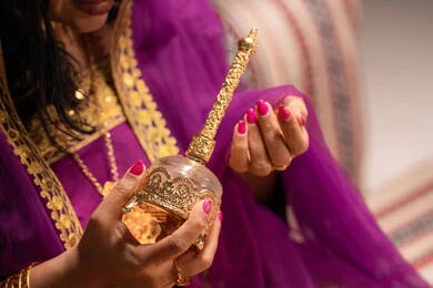 The sound of rose water being sprayed at events, the concept of decoration and a dazzling appearance, adorning with jewelry and gold ornaments, using cosmetics to highlight beauty, an Arab Gulf Emirati bride wearing traditional attire showcasing the preparations and arrangements for the wedding, getting ready to celebrate the night of a lifetime.