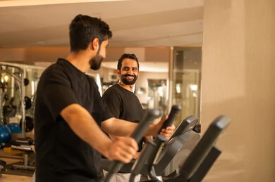 Practicing favorite sports with friends, a youth activity that helps with physical flexibility, the importance of sports in building a strong body, attention to health and physical fitness, a Saudi man practicing exercises to improve body posture and balance, a young Arab Gulf Saudi wearing sportswear exercising on a treadmill.