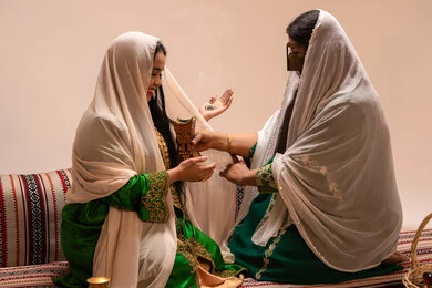 استخدام بخور العود والمسك، أصالة العادات والتقاليد الخليجية، الاحتفال بالمناسبات والأفراح السعيدة, امراة عربية خليجية اماراتية ترتدي الزي الشعبي تحمل بيدها حامل البخور( المبخرة ) تقوم بتبخير العروس، مراسم الأعراس والزواج