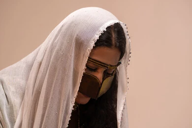 A close-up image of an Arab Gulf Emirati bride wearing a burqa and a white hijab, looking at something, wearing traditional Emirati attire for occasions and celebrations, preparing for the wedding night.
