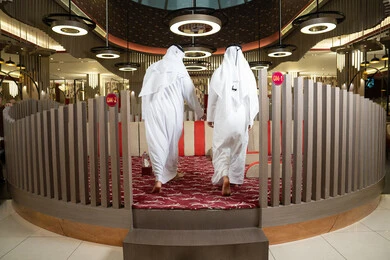 The spirit of social communication in Emirati gatherings, spending enjoyable times outdoors, the concept of authenticity and modernity, two Arab Gulf Emirati men wearing the kandura and ghutrah, entering a luxurious modern majlis with an elegant and comfortable atmosphere.
