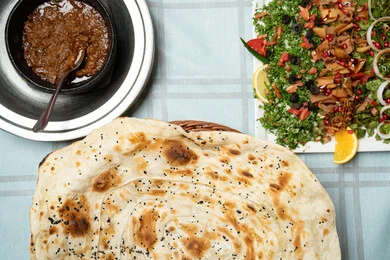 A close-up image of a table filled with delicious Eastern dishes, the concept of generosity and hospitality, sharing food in a spirit of warmth and closeness, values and traditions of Arab hospitality.