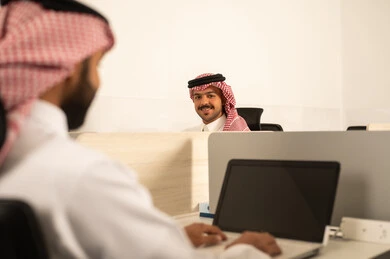 Conversations and discussions within the team, designated spaces for each employee in the company, focus and meticulous work, business and company development, work meetings and project completion, discussing plans and explaining job tasks, Arab Saudi Gulf colleagues using laptops. Conversations and discussions within the team, designated spaces for each employee in the company, focus and meticulous work, business and company development, work meetings and project completion, discussing plans and explaining job tasks, Arab Saudi Gulf colleagues using laptops.