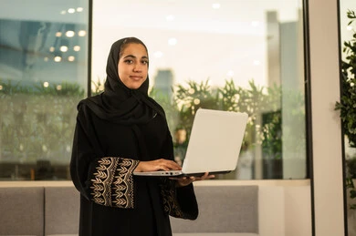 Team discussions and dialogues, online work meetings and project completion, working in offices and companies, focus and meticulous work, business and company development, discussing plans and explaining work tasks, an Arab Gulf Saudi female employee wearing an abaya and hijab using a laptop. Team discussions and dialogues, online work meetings and project completion, working in offices and companies, focus and meticulous work, business and company development, discussing plans and explaining work tasks, an Arab Gulf Saudi female employee wearing an abaya and hijab using a laptop.