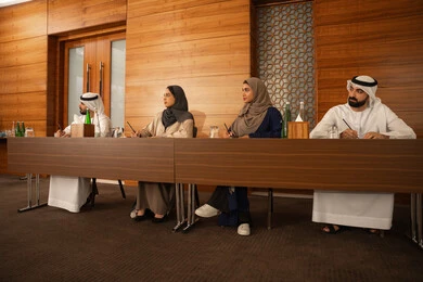 Understanding and cooperation among colleagues and developing strategic plans to achieve goals, holding a meeting inside the company headquarters, a group of Arab Gulf Emirati employees learning work methods and professional development, teamwork and team spirit, using writing to ensure a clear and comprehensive understanding of the work.