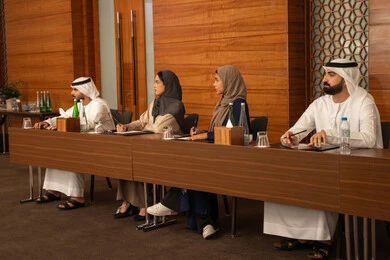 Collaboration and understanding among colleagues and setting strategic plans to achieve goals, holding a meeting inside the company headquarters, a group of Arab Gulf Emirati employees learning work methods and professional development, teamwork and team spirit, using writing to ensure a clear and comprehensive understanding of the work.