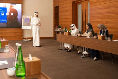 Writing to ensure a clear and comprehensive understanding of the work, cooperation and understanding among colleagues, and setting strategic plans to achieve goals, holding a meeting inside the company headquarters, a group of Arab Gulf Emirati employees learning work methods and professional development, teamwork and team spirit.