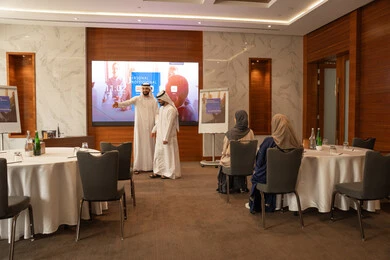 Welcoming new colleagues at a meeting, a group of Arab Gulf Emirati employees learning work methods and professional development, cooperation and understanding among colleagues, and setting strategic plans to achieve goals, holding a meeting inside the company headquarters, teamwork and team spirit.