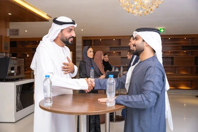 Unity and teamwork, companies in the United Arab Emirates, partnership and cooperation in accomplishing tasks, discussion and understanding among employees, exchanging experiences and information to achieve goals, strategic planning and organization, two Arab Gulf businessmen from the UAE discussing work methods and professional development.