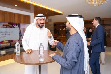 Developing strategies for companies in the United Arab Emirates, partnership and collaboration in accomplishing tasks, discussion and understanding among employees, exchanging experiences and information to achieve goals, strategic planning and organization, two Arab Gulf businessmen from the UAE discussing work methods and professional development.