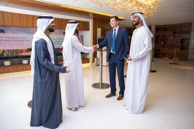 The United Arab Emirates, strategic plans to achieve goals, discussion and understanding among employees, holding a meeting within the company, professions and office jobs, attention to elegance and external appearance, a group of Arab Gulf businessmen from the UAE discussing work methods and professional development with a foreign businesswoman.